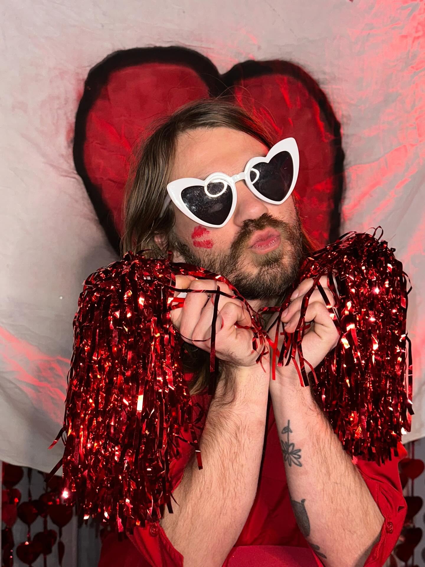 Performer with heart glasses and tinsel